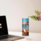 Tumbler on desk beside laptop, ocean-themed workspace
